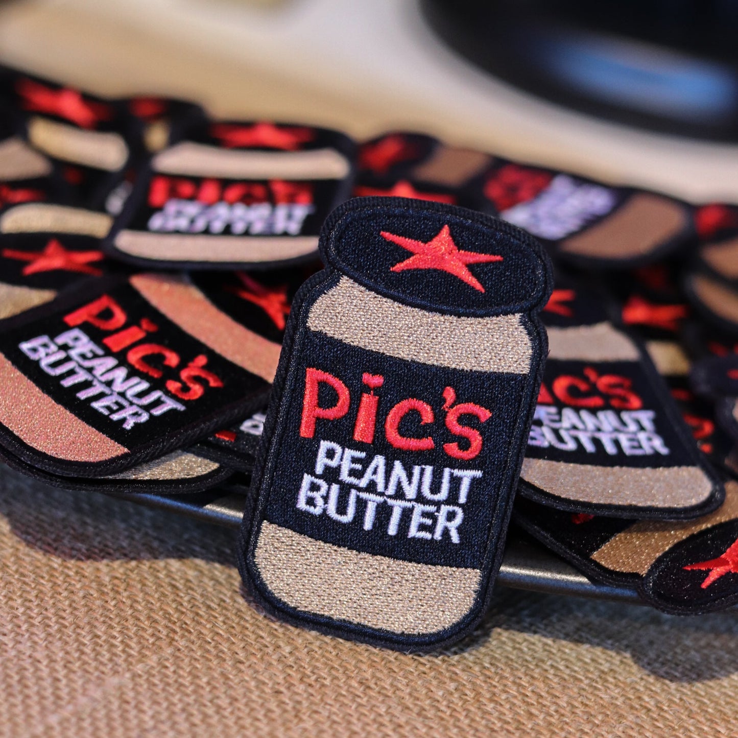 Patches with 'Pic's Peanut Butter' branding on a textured surface